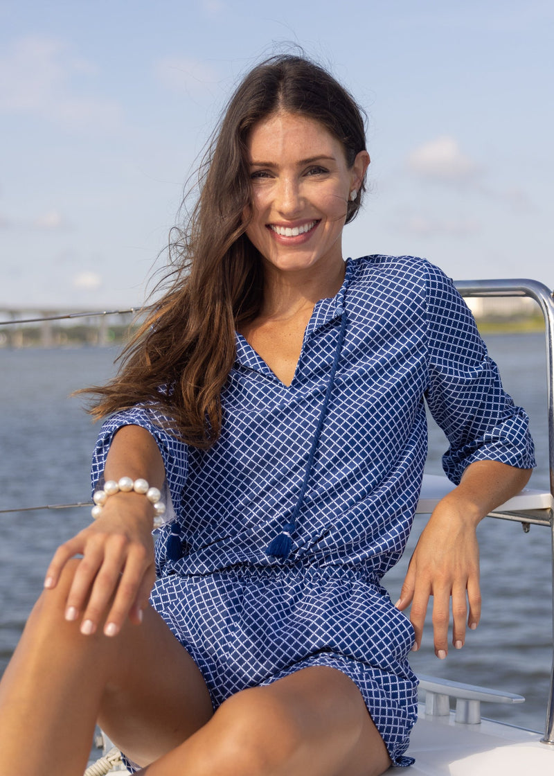 Woman wearing Nautical Ruffle Sleeve Romper sitting on boat